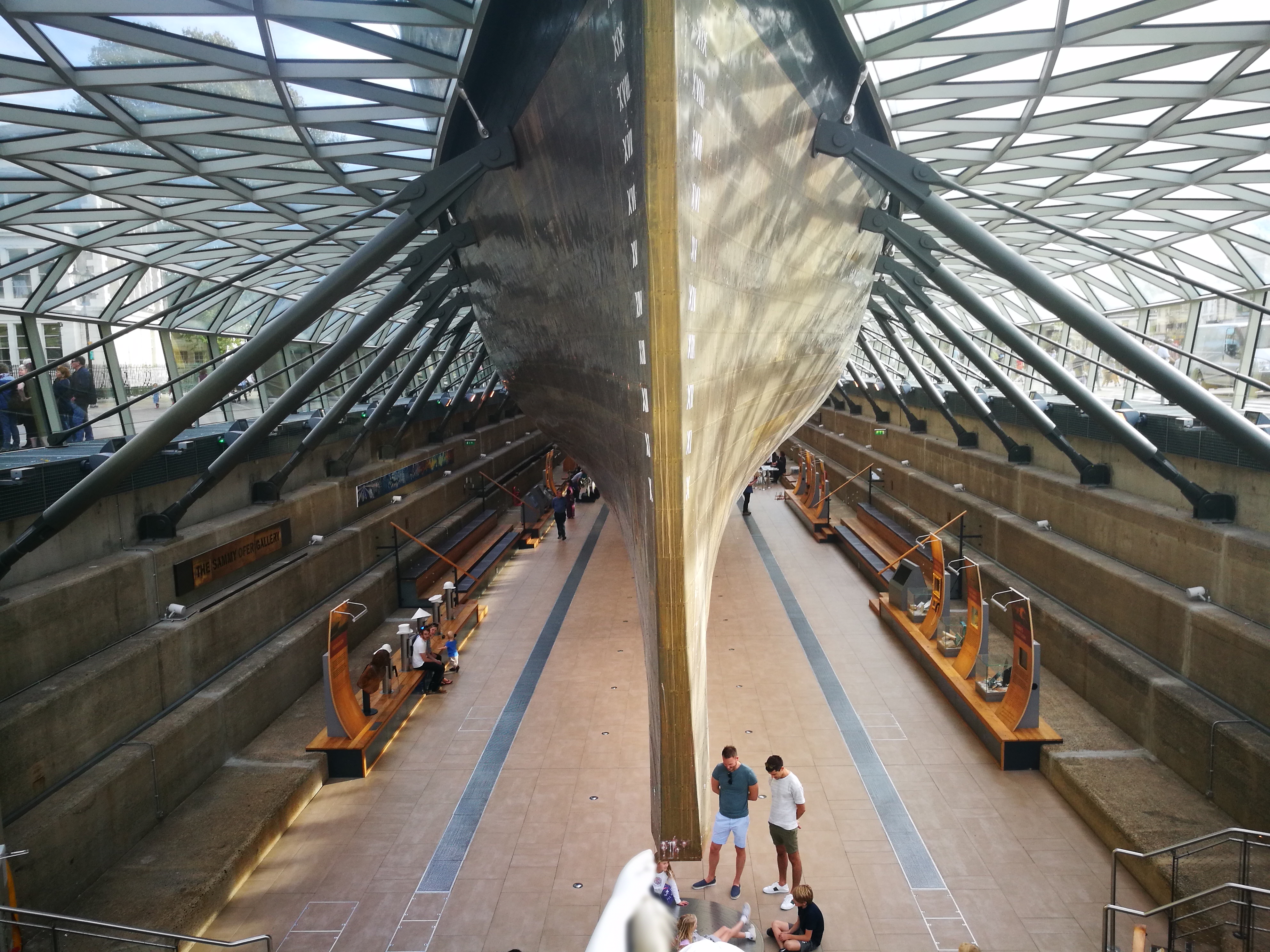the ship's hull, taken from underneath, showing the architectural ribbing of the dry dock supports and the crystal glass 
